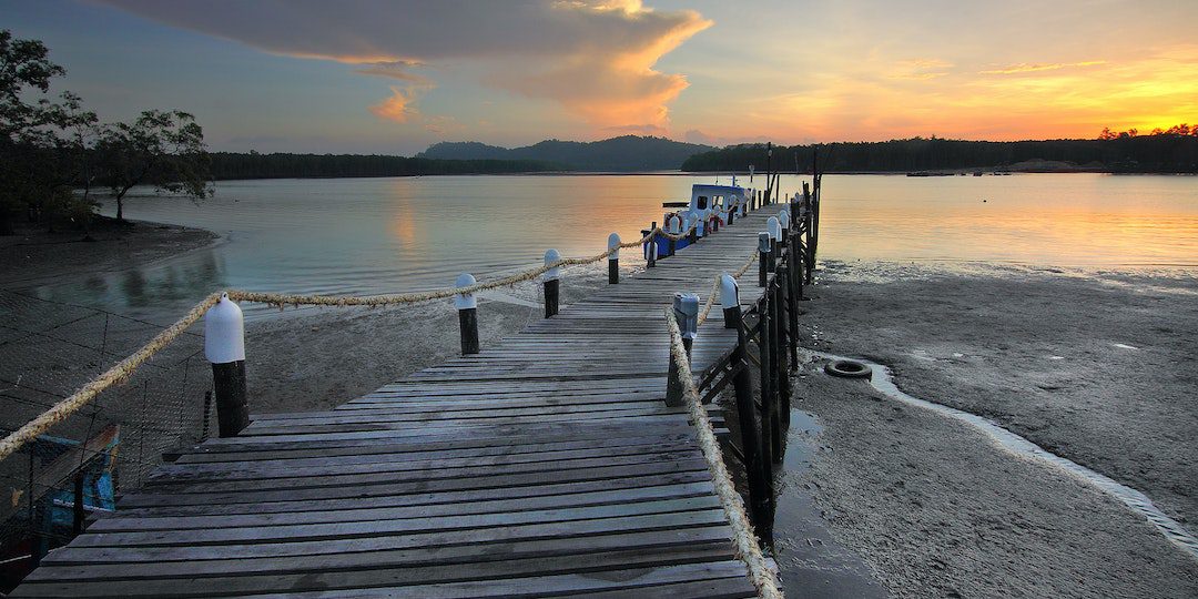 Brown Wooden Dock on Shore Near Ocean